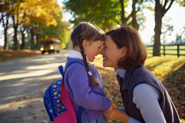 Mother and Daughter Waiting for School Bus --- Image by © Jim Craigmyle/CORBIS