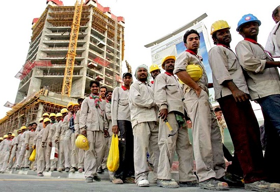 Foreign workers stand in line to take a bus that will transport them to where they live at the end of their shift at a construction site in Dubai on April 16, 2008. Emarati officials warned during a two-day conference on National Identity held in Abu Dhabi of the dangers of social instability created by large foreign minorities. AFP PHOTO/KARIM SAHIB (Photo credit should read KARIM SAHIB/AFP/Getty Images)