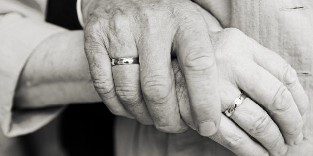 Elderly couple at golden wedding holding hands
